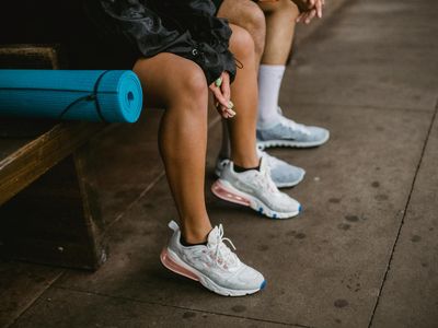 Close-up of comfortable sneakers on a yoga mat.